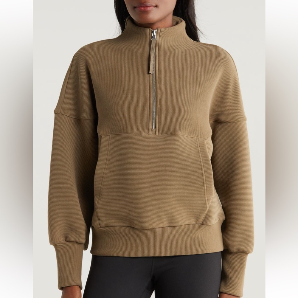 Varley pullover with quarter zip and sleek front pocket, quality cuffs and hem.